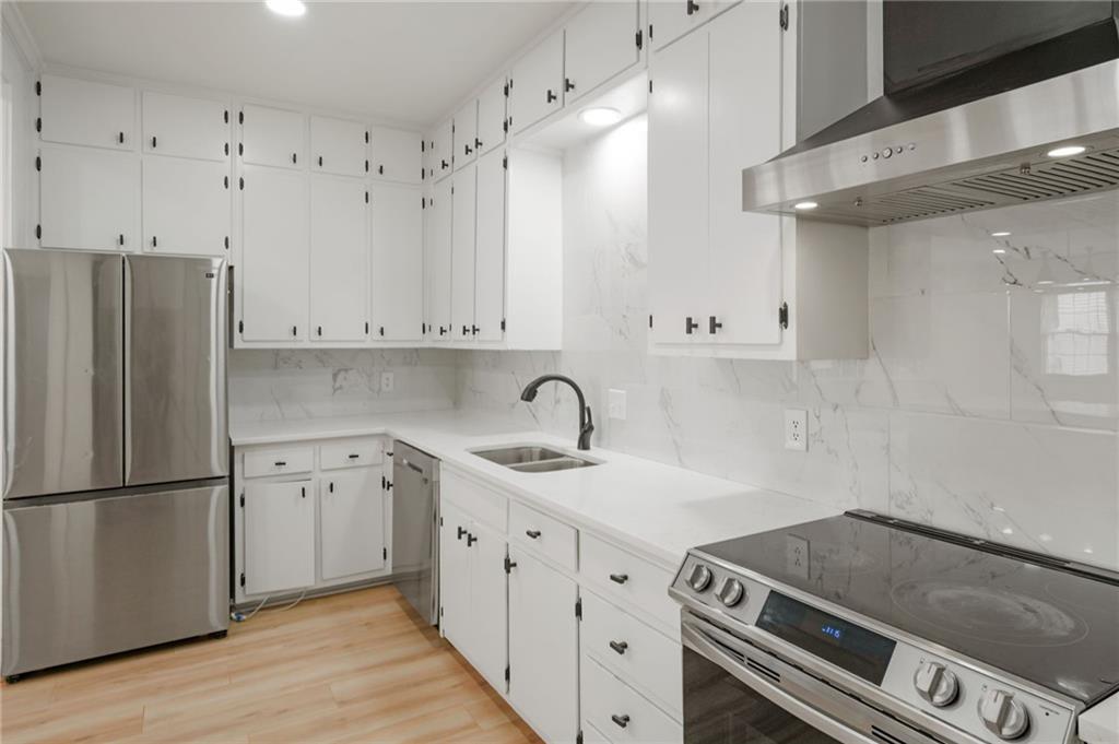 3649 Peachtree Road Northeast, Unit 305 Atlanta, GA 30319 - Photo 45 of 58 a kitchen with granite countertop a sink stove and refrigerator
