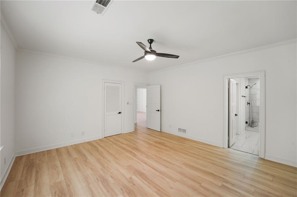 3649 Peachtree Road Northeast, Unit 305 Atlanta, GA 30319 - Photo 46 of 58 a view of a room with wooden floor and a ceiling fan