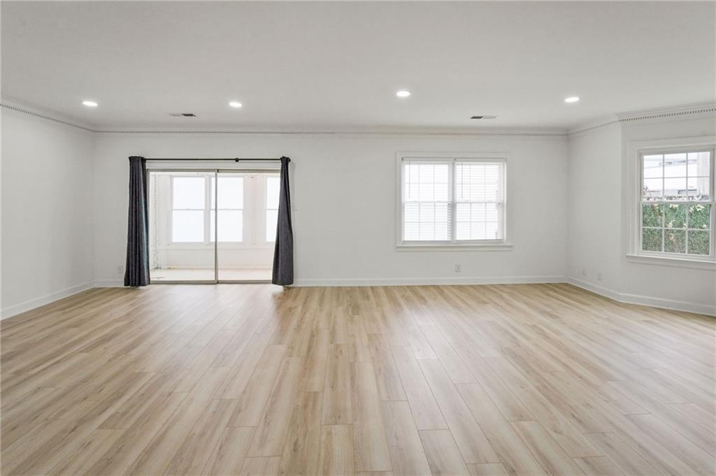 3649 Peachtree Road Northeast, Unit 305 Atlanta, GA 30319 - Photo 57 of 58 an empty room with wooden floor and windows