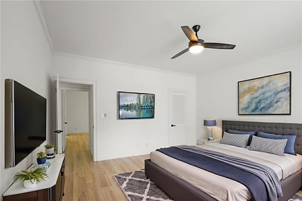 3649 Peachtree Road Northeast, Unit 305 Atlanta, GA 30319 - Photo 6 of 58 a bedroom with a bed and a flat screen tv