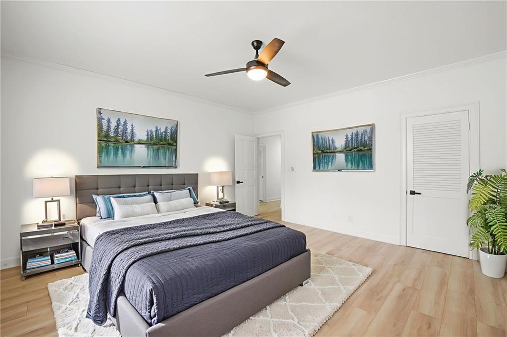 3649 Peachtree Road Northeast, Unit 305 Atlanta, GA 30319 - Photo 7 of 58 a bedroom with a bed and a painting on the wall