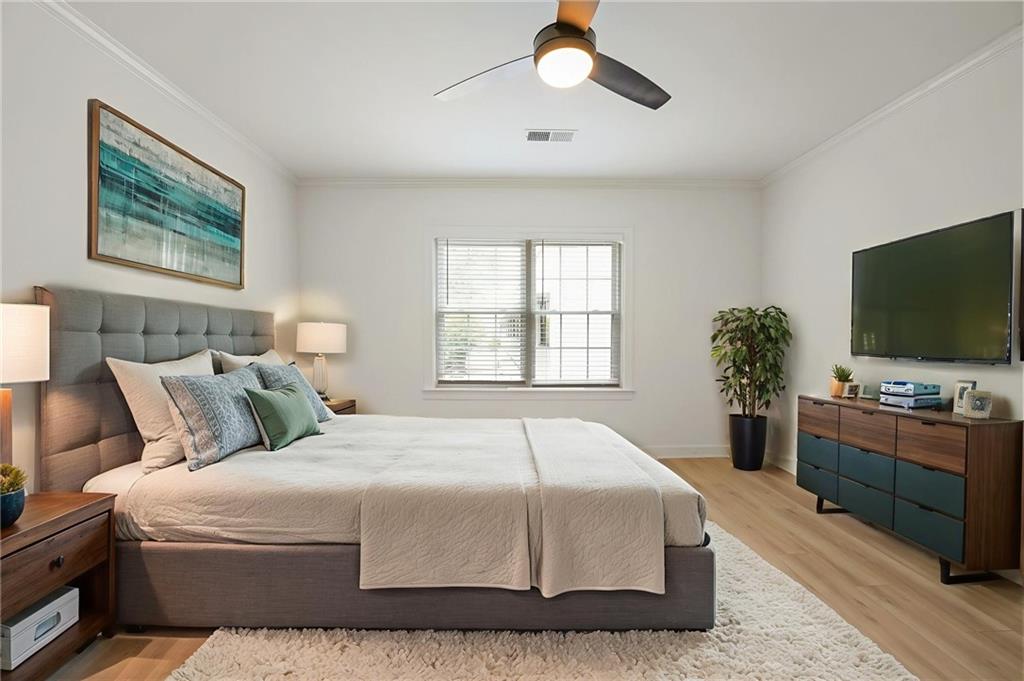 3649 Peachtree Road Northeast, Unit 305 Atlanta, GA 30319 - Photo 8 of 58 a bedroom with a large bed and a flat screen tv