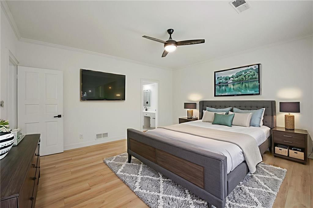 3649 Peachtree Road Northeast, Unit 305 Atlanta, GA 30319 - Photo 9 of 58 a bedroom with a bed and a flat screen tv