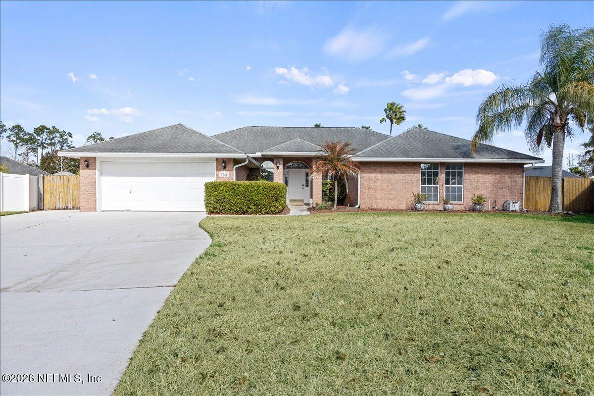9750 Brockham Court Jacksonville, FL 32221 - Photo 1 of 39 a front view of a house with a yard
