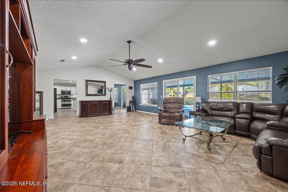 9750 Brockham Court Jacksonville, FL 32221 - Photo 14 of 39 a living room with furniture and a flat screen tv