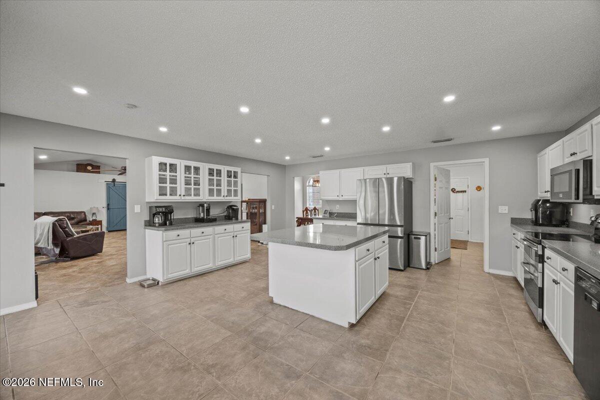 9750 Brockham Court Jacksonville, FL 32221 - Photo 17 of 39 a kitchen with white cabinets and counter