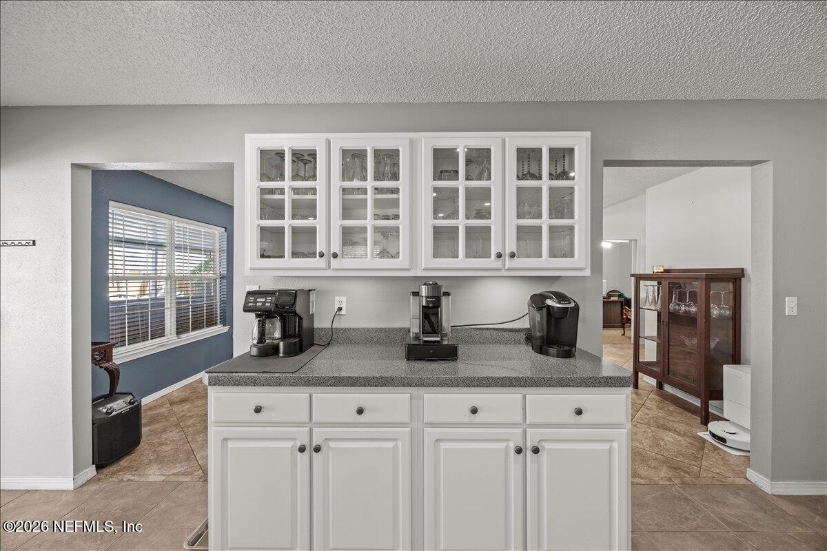 9750 Brockham Court Jacksonville, FL 32221 - Photo 19 of 39 a kitchen with granite countertop cabinets and window