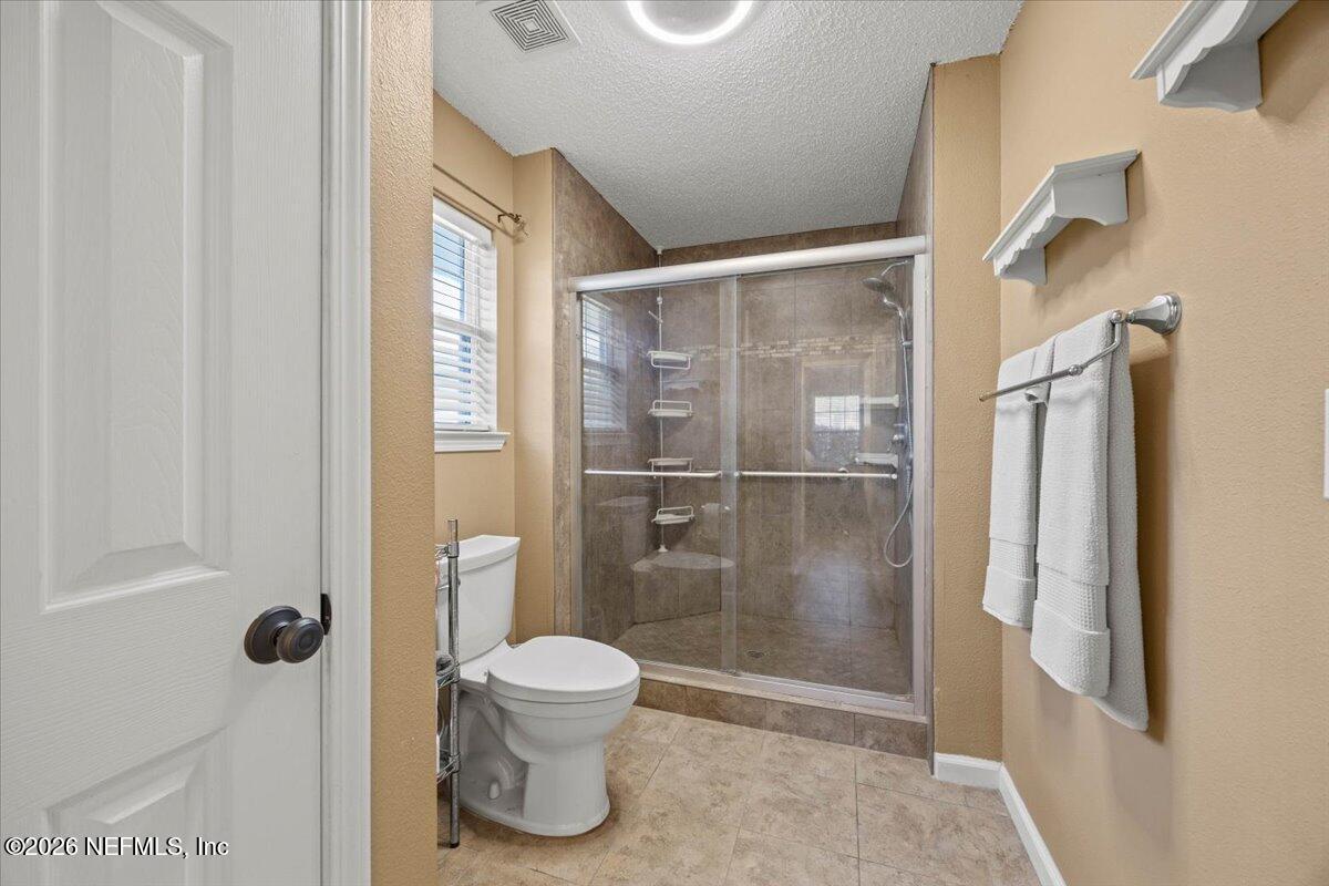 9750 Brockham Court Jacksonville, FL 32221 - Photo 28 of 39 a bathroom with a shower and a toilet
