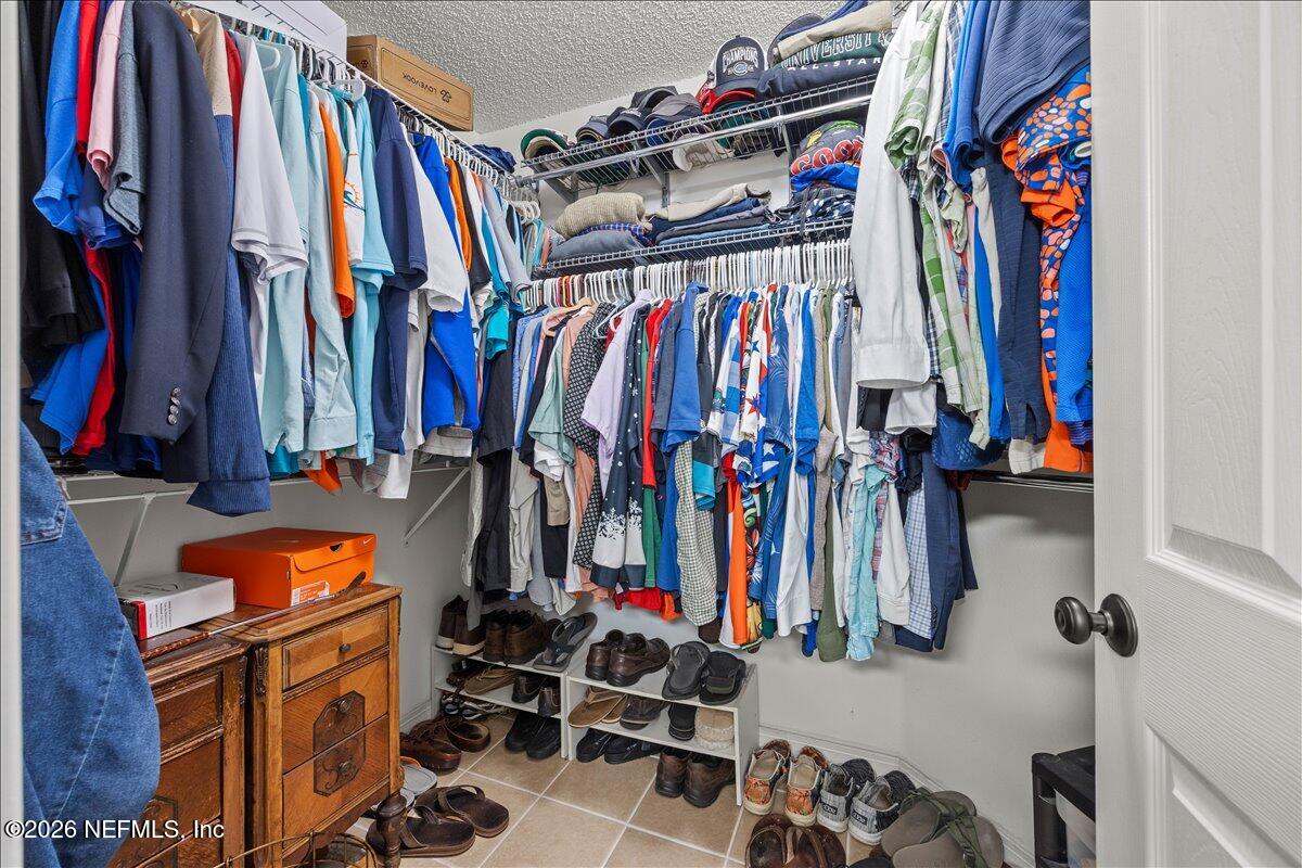 9750 Brockham Court Jacksonville, FL 32221 - Photo 29 of 39 a view of walk in closet with clothes and shoes