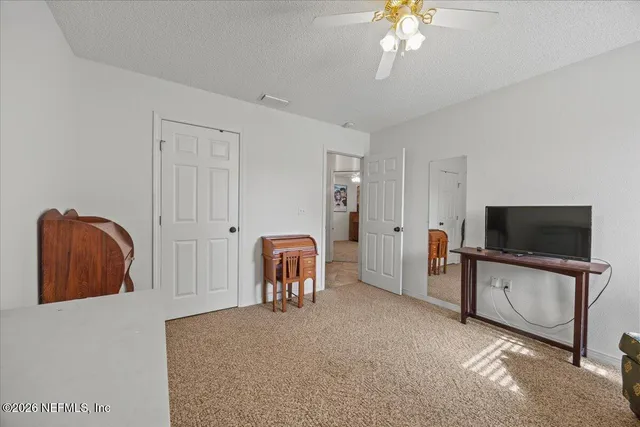 a view of a house with backyard and a tree