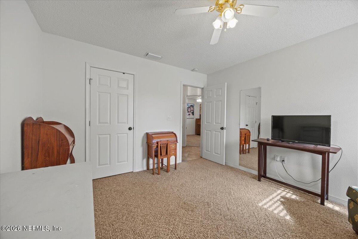 9750 Brockham Court Jacksonville, FL 32221 - Photo 35 of 39 a view of a livingroom with furniture and a flat screen tv
