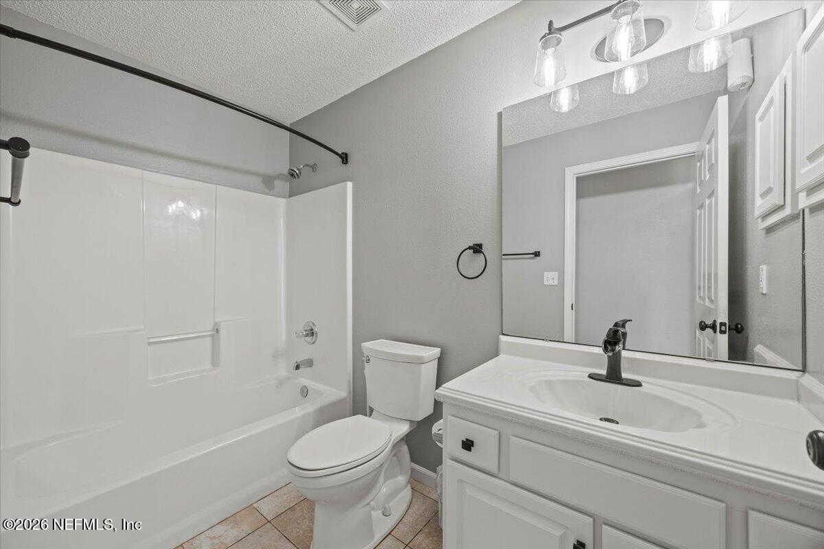 9750 Brockham Court Jacksonville, FL 32221 - Photo 36 of 39 a bathroom with a sink a toilet and a mirror