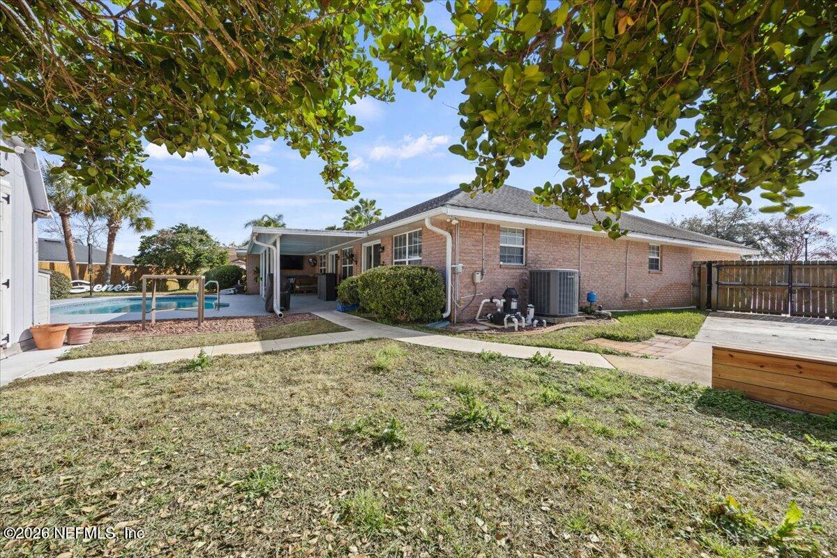9750 Brockham Court Jacksonville, FL 32221 - Photo 37 of 39 a view of a house with backyard and a tree