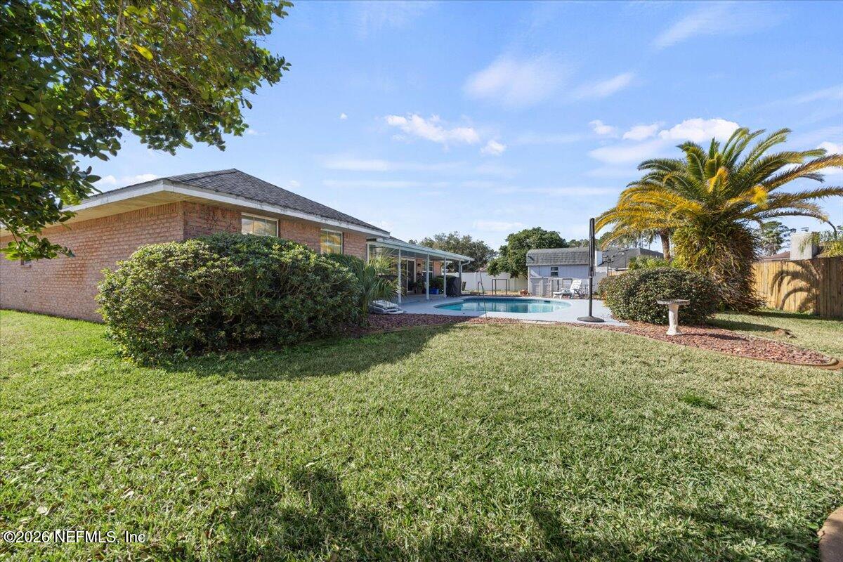 9750 Brockham Court Jacksonville, FL 32221 - Photo 38 of 39 a front view of house with yard and green space