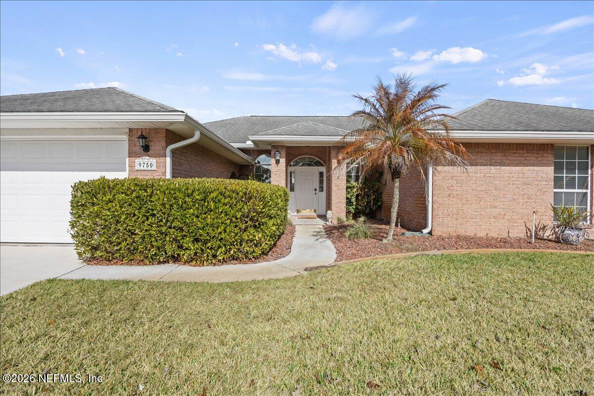 9750 Brockham Court Jacksonville, FL 32221 - Photo 4 of 39 a view of a house with a yard and potted plants