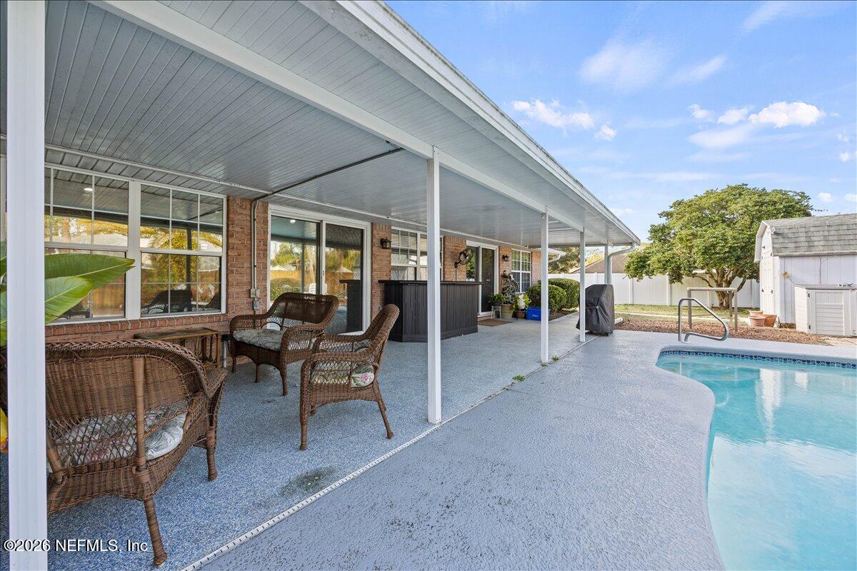 9750 Brockham Court Jacksonville, FL 32221 - Photo 6 of 39 a patio with table and chairs
