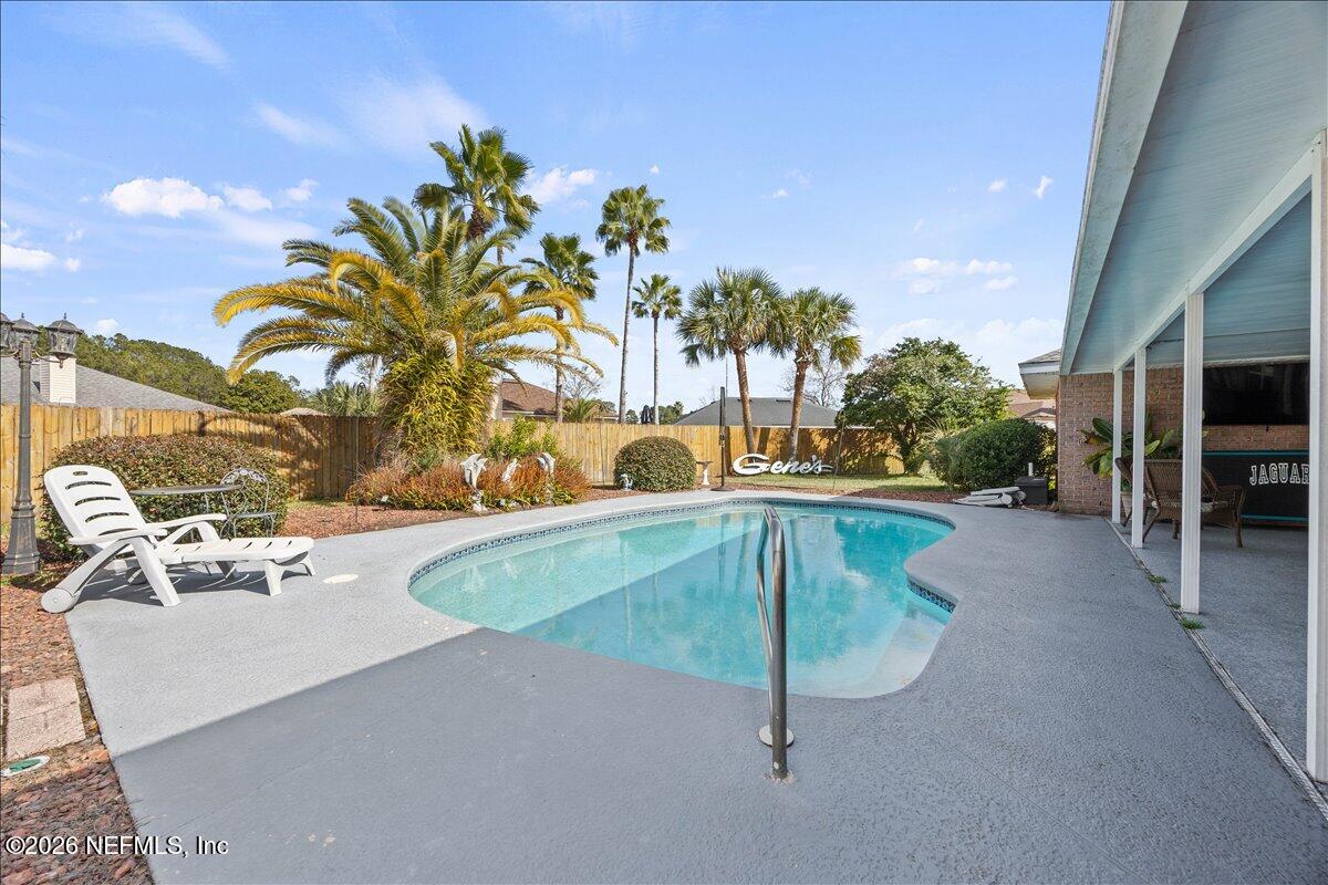 9750 Brockham Court Jacksonville, FL 32221 - Photo 7 of 39 a swimming pool with outdoor seating and yard