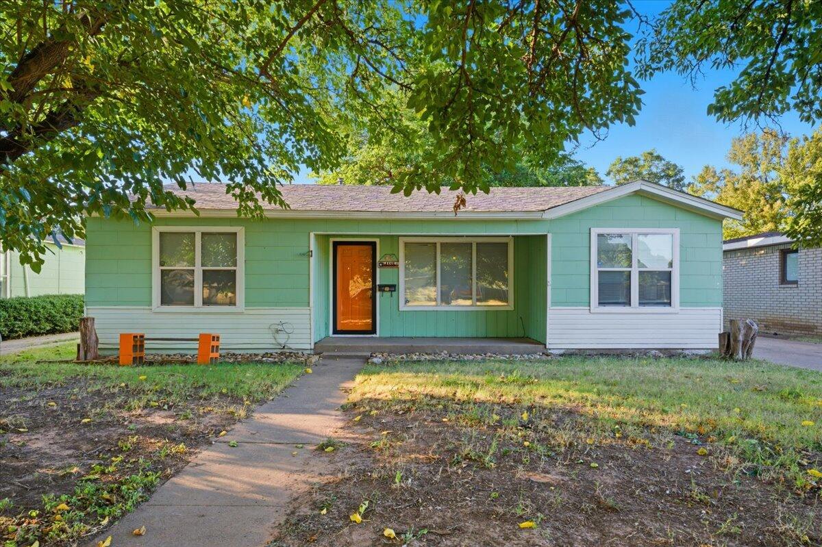 a front view of house with yard and green space
