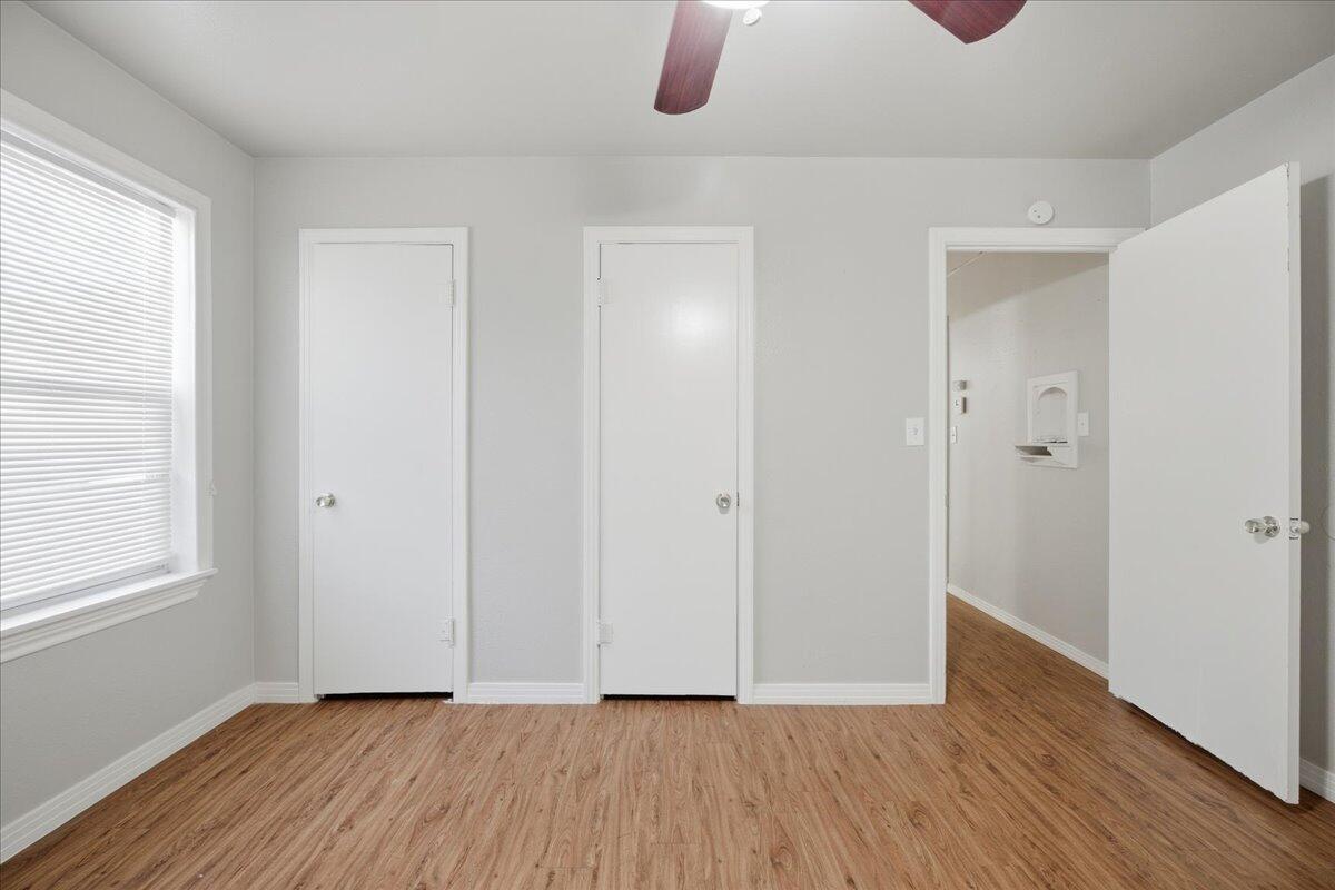 4115 31st Street Lubbock, TX 79410 - Photo 12 of 16 a view of an empty room with wooden floor and a window