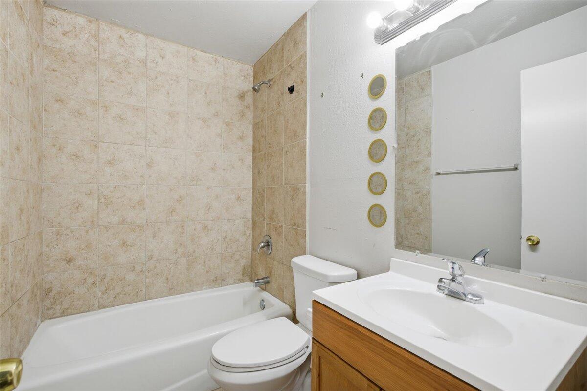4115 31st Street Lubbock, TX 79410 - Photo 15 of 16 a bathroom with a sink toilet and shower