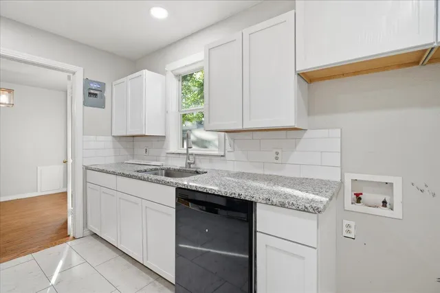 a kitchen with stainless steel appliances granite countertop a sink stove and cabinets