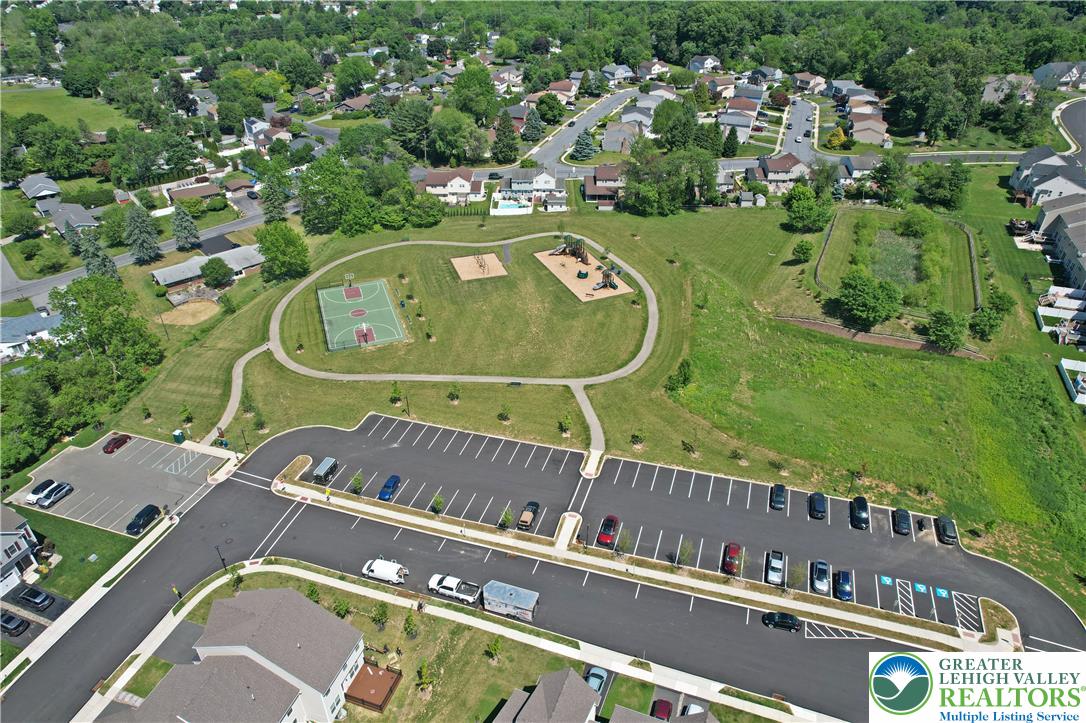 4502 Benjamin Court Emmaus, PA 18049 - Photo 50 of 53 An aerial perspective showcases a vibrant community park with recreational courts and ample parking, surrounded by residential areas.