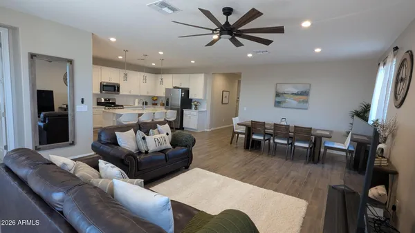 a living room with furniture kitchen view and a dining table