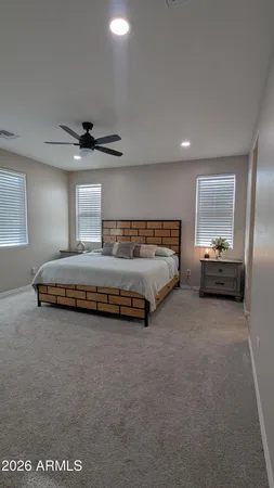 a living room with furniture and a ceiling fan