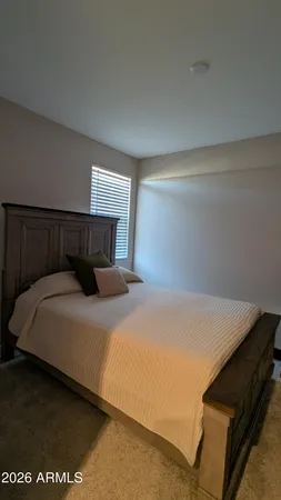 a bedroom with a bed and window