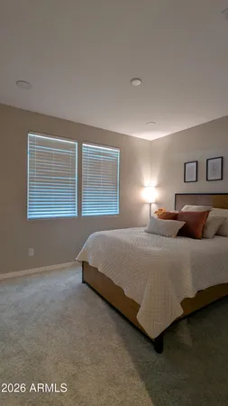 a bedroom with a bed and chair