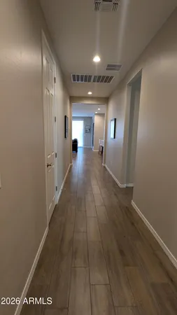 a view of a hallway with wooden floor