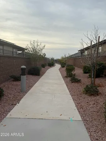 a pathway of a house with a yard