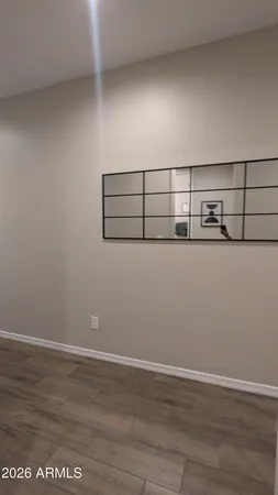 a view of a room with wooden floor