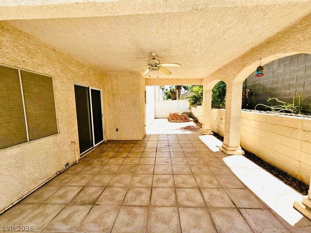 5953 Crumbling Ridge Street Henderson, NV 89011 - Photo 41 of 42 Relax and entertain on this covered patio, featuring graceful archways and a tiled floor.