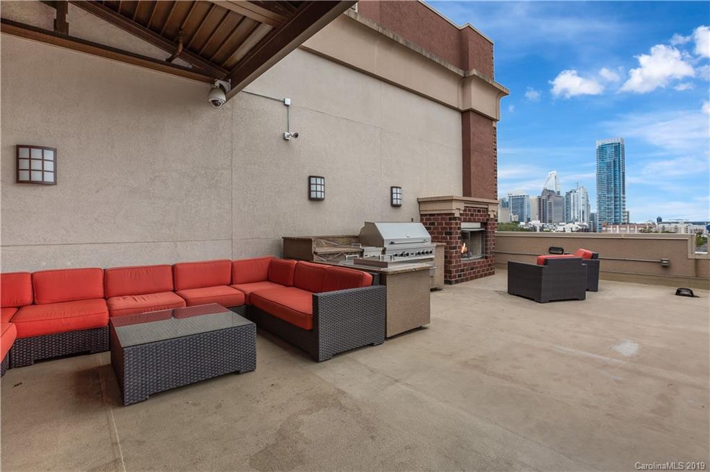715 North Graham Street, Unit 210 Charlotte, NC 28202 - Photo 12 of 17 a outdoor living space with furniture and a fireplace
