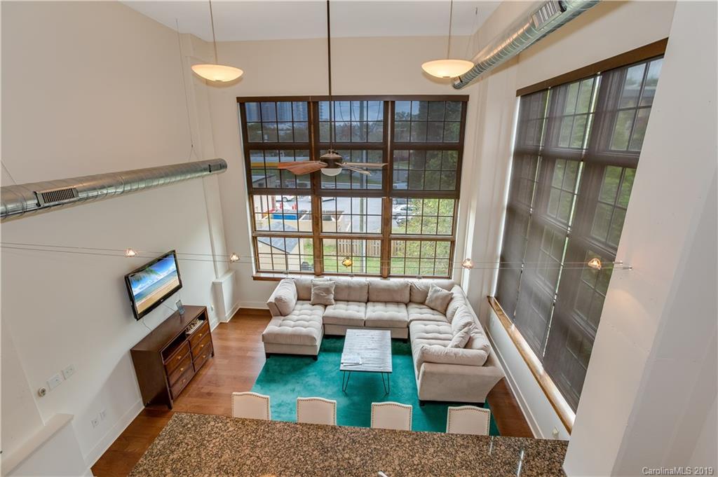 715 North Graham Street, Unit 210 Charlotte, NC 28202 - Photo 7 of 17 a living room with furniture and a flat screen tv