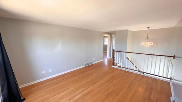 wooden floor in an empty room with stairs