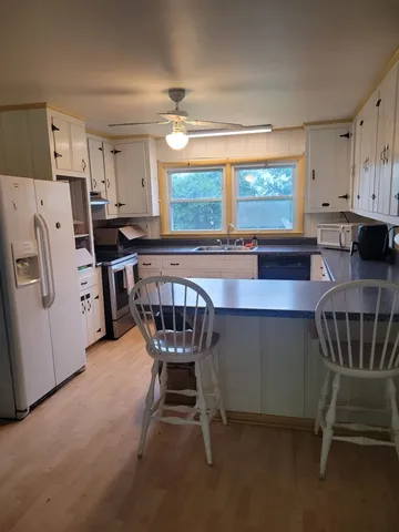 a view of a livingroom with furniture and a window