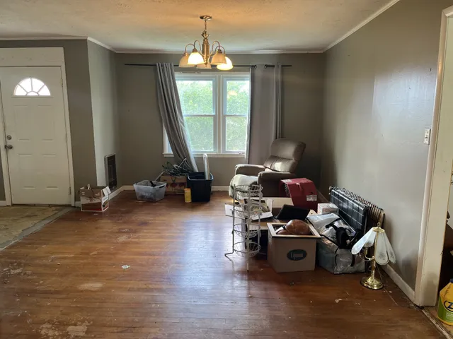 an empty room with windows and cabinet