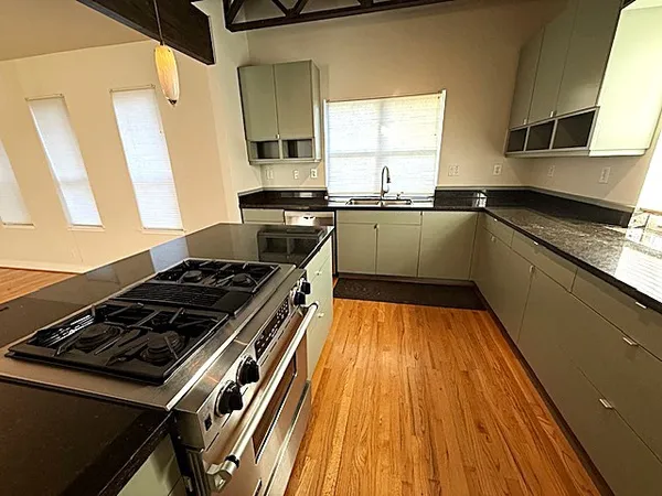 a kitchen with wooden floors and a stove