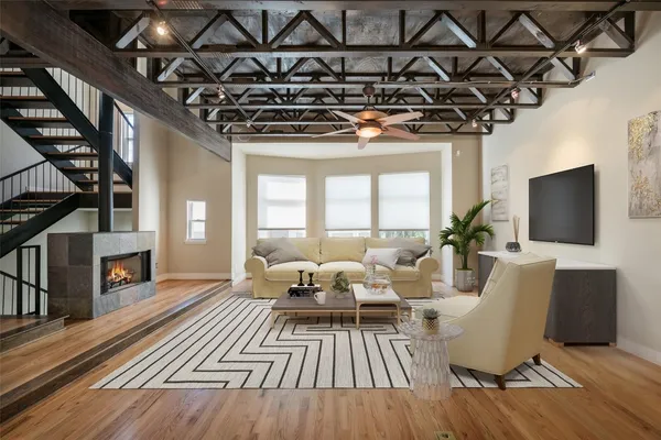 a living room with furniture or chandelier and a wooden floor