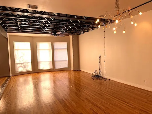 a view of a room with wooden floor and window