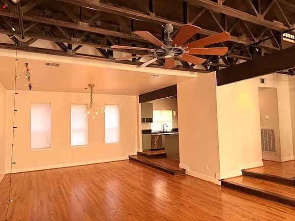 a view of a room with wooden floor