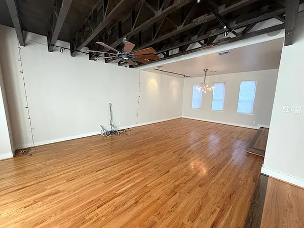 a view of a room with wooden floor