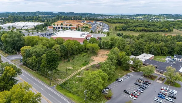 an aerial view of residential houses with outdoor space and street view