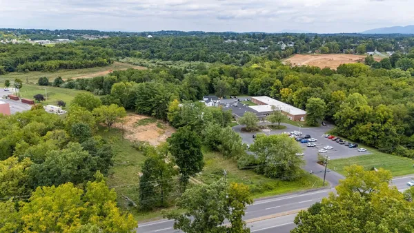 an aerial view of a house with a yard and lake view