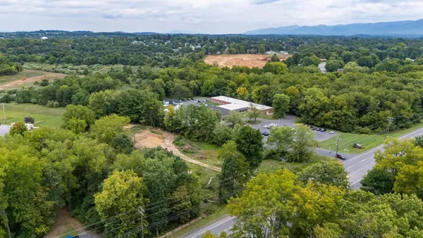 an aerial view of mountain with trees in the background
