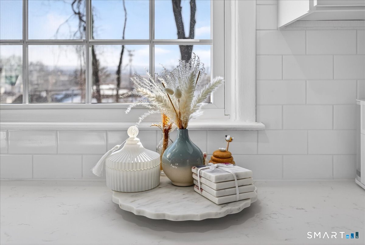 114 Daniel Road Hamden, CT 06517 - Photo 11 of 32 a table with a vase and a vase on it