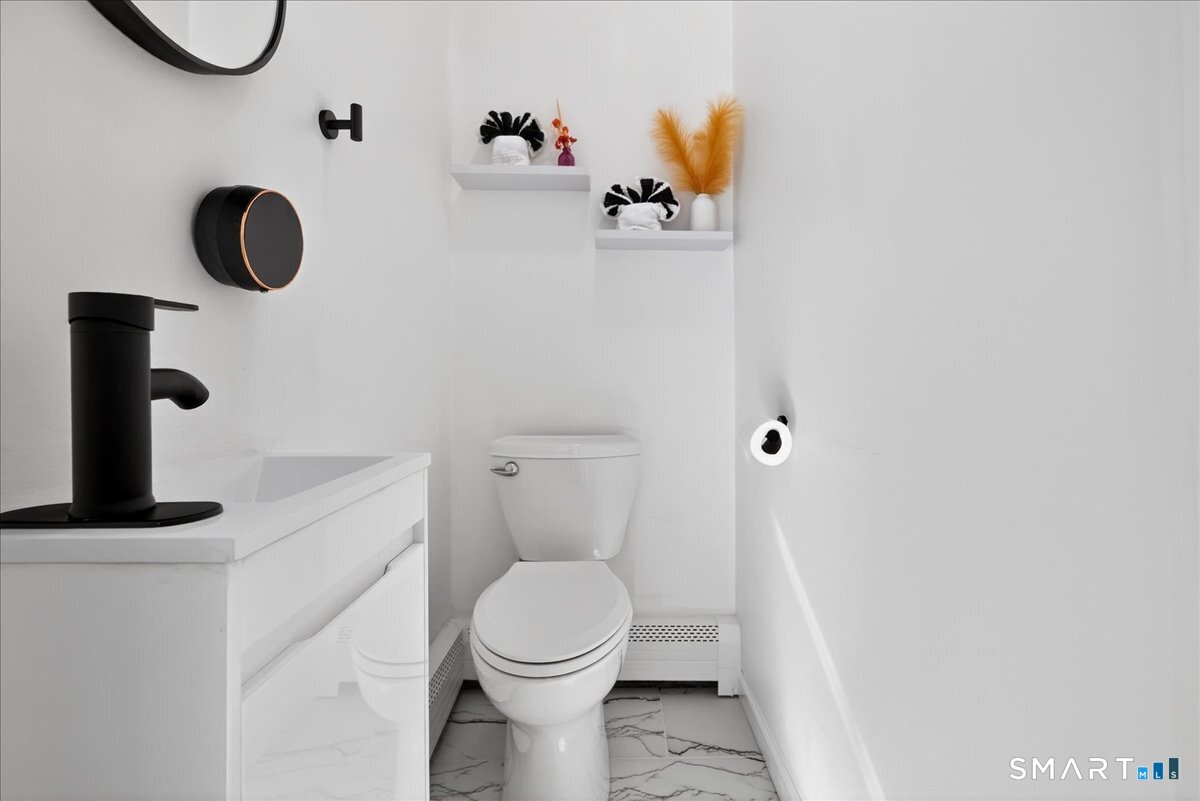 114 Daniel Road Hamden, CT 06517 - Photo 14 of 32 a bathroom with a toilet and a mirror