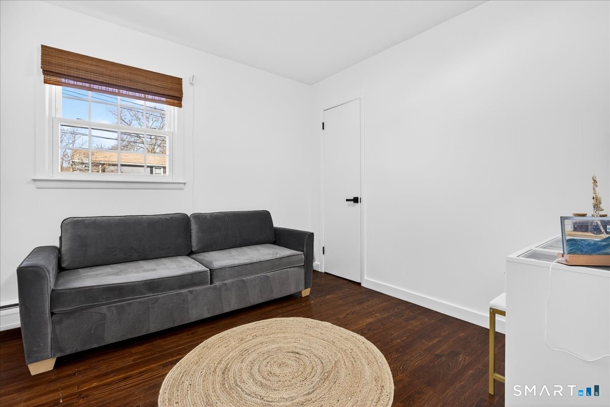 114 Daniel Road Hamden, CT 06517 - Photo 18 of 32 a living room with furniture and a wooden floor